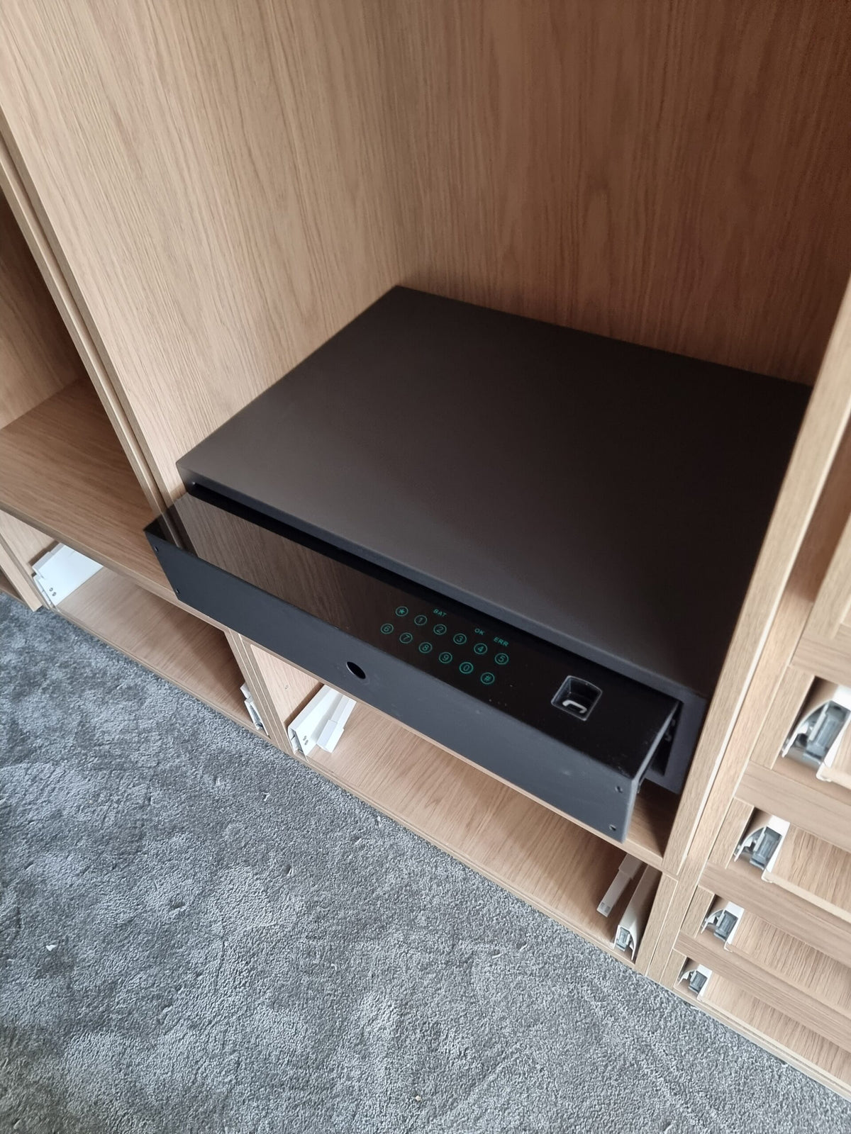 Wardrobe drawer safe with illuminated keypad and fingerprint reader on the drawer front
