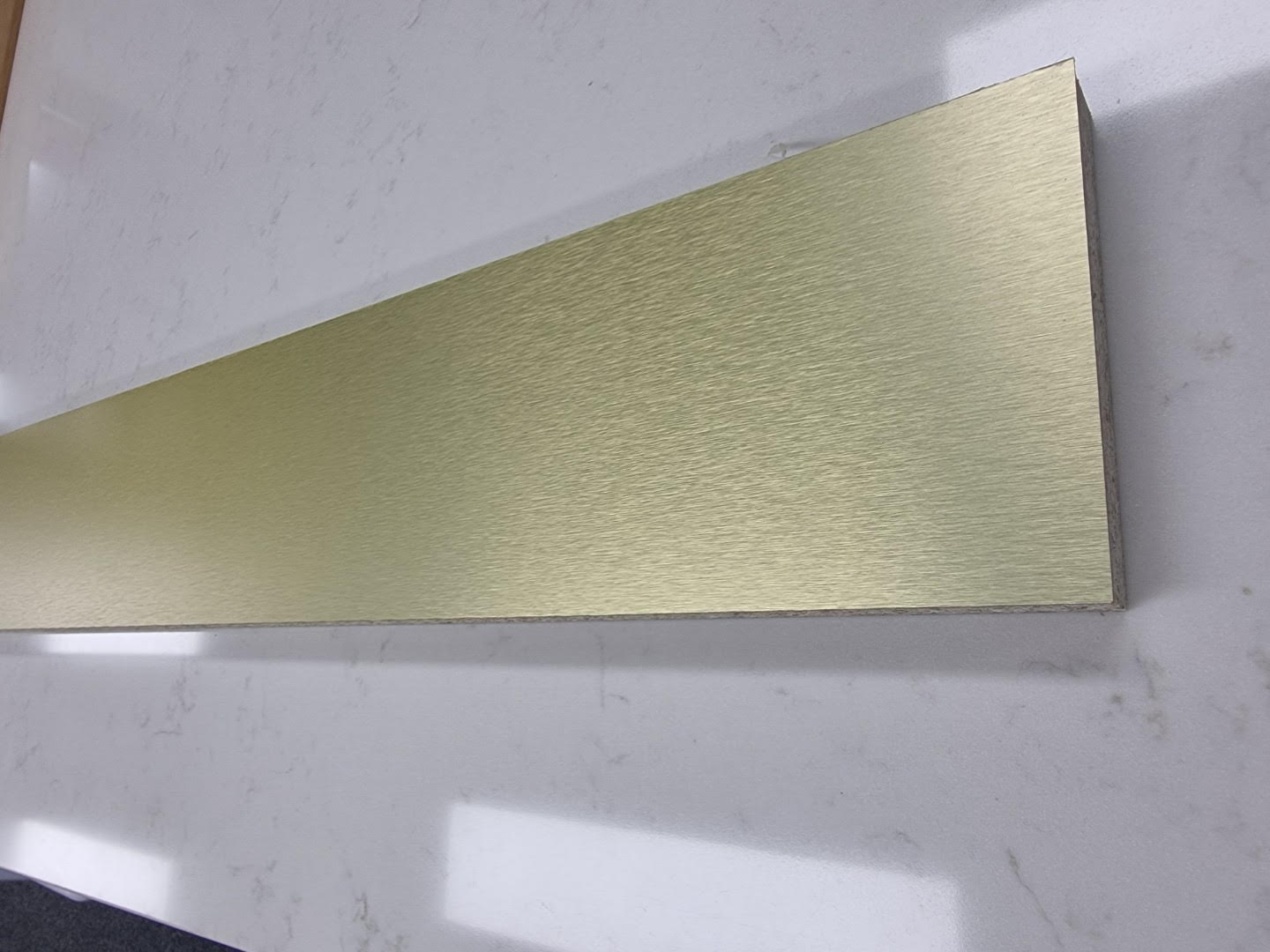 Stuck on board Brushed Gold colour Aluminium Kickboard Laminate Height 150mm.